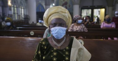 A parishioner wearing face mask to protect against coronavirus, attends a morning Christmas Mass at Holy Cross Cathedral in Lagos, Nigeria, Friday Dec. 25, 2020. (AP Photo)