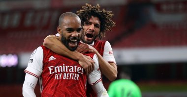 Arsenal's Alexandre Lacazette (L) and Mohamed Elneny celebrate a goal during the Premier League match against Chelsea at the Emirates Stadium in London, Britain, Dec. 26, 2020. (AFP Photo)