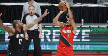 Portland Trail Blazers' CJ McCollum (R) shoots over Houston Rockets' P.J. Tucker during an NBA game at the Moda Center in Portland, Oregon, U.S., Dec. 26, 2020. (Reuters Photo)