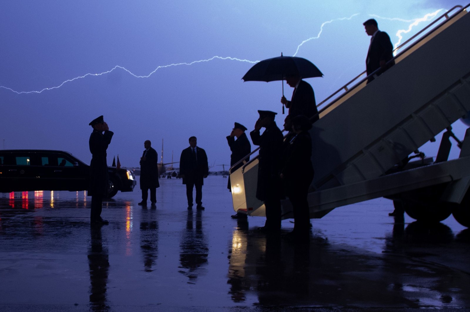 U.S. President Donald Trump disembarks from Air Force One as lightning splits the sky during a storm, Maryland, U.S., Aug. 28, 2020. (AFP Photo)