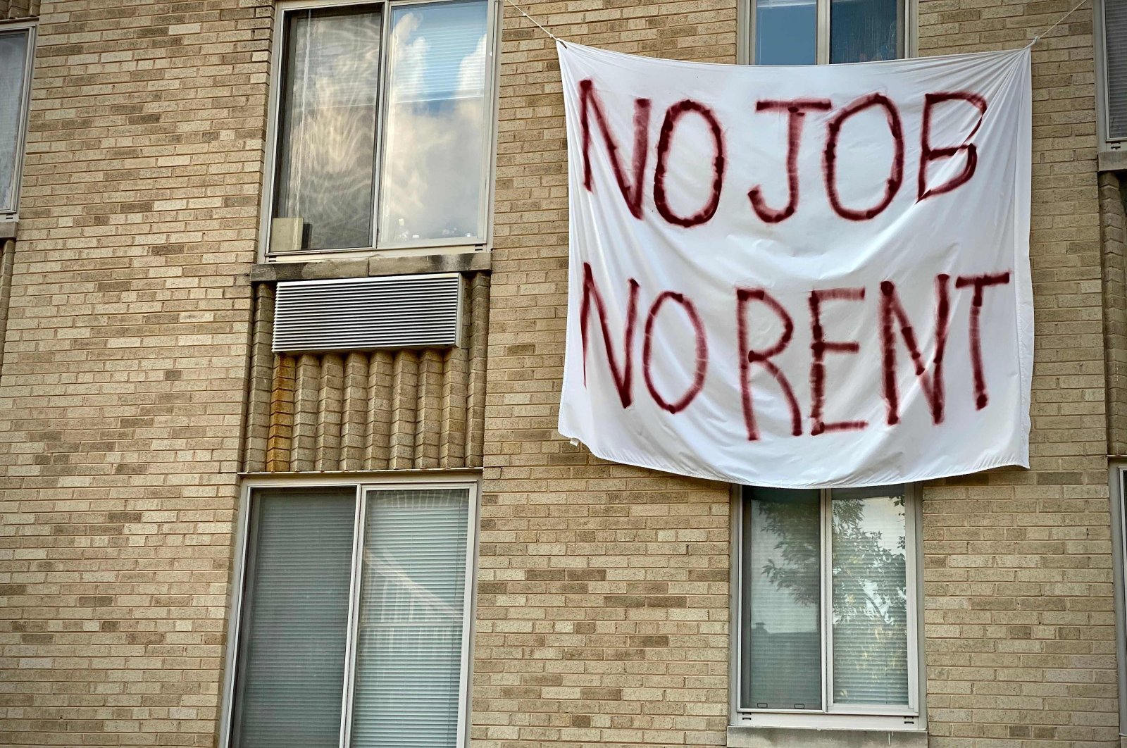 In this file photo taken on August 09, 2020, a banner against renters eviction reading “no job, no rent” is displayed on a controlled rent building in Washington, DC. (AFP Photo)