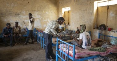 Surgeon and doctor-turned-refugee Tewodros Tefera checks the wounds of a Tigrayan survivor from Mai-Kadra, Ethiopia, at the Hamdeyat Transition Center near the Sudan-Ethiopia border, eastern Sudan, Dec. 15, 2020. (AP Photo)