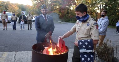 In this Oct.13, 2020 file photo, Jondavid Longo (C), the Republican mayor of Slippery Rock, Pa., presides over a Boy Scouts flag retirement ceremony where worn-out flags are cut up and burned in Slippery Rock. (AP Photo)