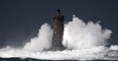 High waves and strong winds hit the Lighthouse of the Chenal du Four in Porspoder, western France, Dec. 27, 2020, as Storm Bella strikes the coast of Britanny. (AFP Photo)