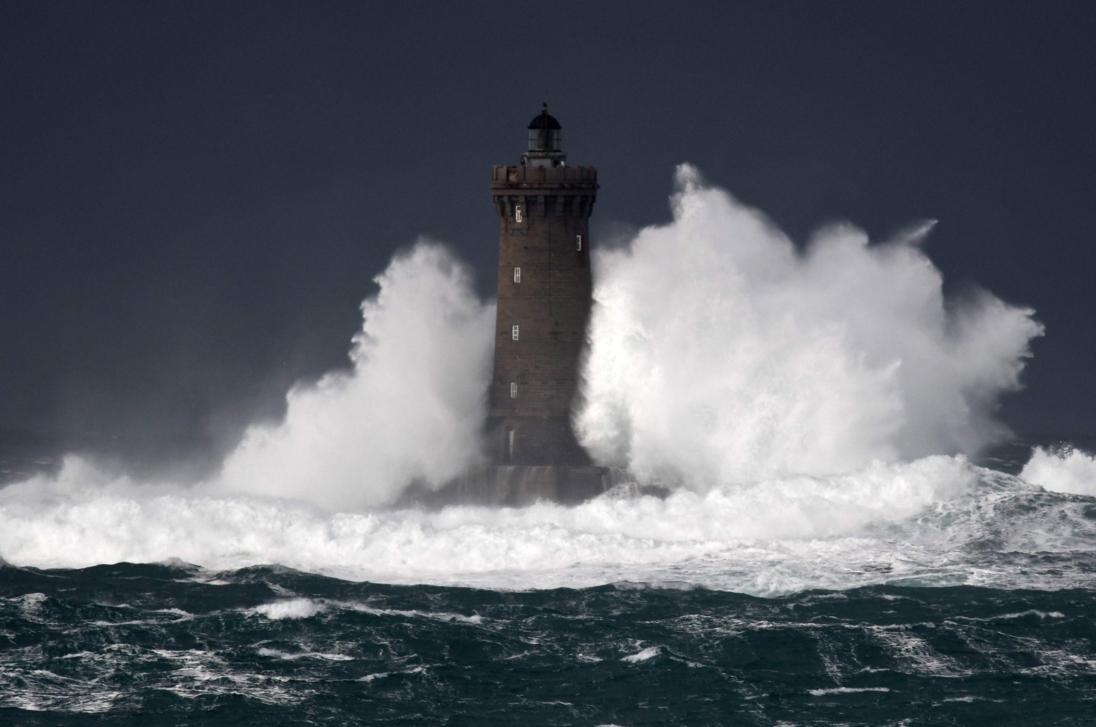 High waves and strong winds hit the Lighthouse of the Chenal du Four in Porspoder, western France, Dec. 27, 2020, as Storm Bella strikes the coast of Britanny. (AFP Photo)
