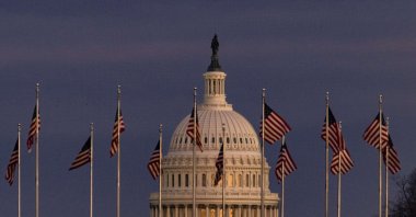 The U.S. Capitol building is seen past the Washington Monument as the sun sets in Washington, D.C., Dec. 26, 2020. ( AFP Photo)