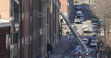 Firefighters ride on an aerial ladder as they inspect buildings damaged in a Christmas Day explosion in Nashville, Tennessee, U.S., Dec. 28, 2020. (AP Photo)