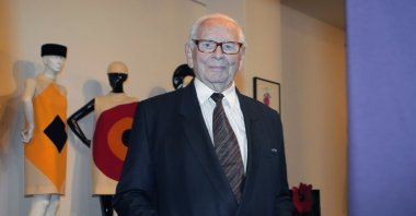 French fashion designer Pierre Cardin poses with a dress on a mannequin during the inauguration of the Pierre Cardin Museum in Paris, France, Nov. 13, 2014. (AP Photo)