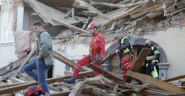Workers clear a building damaged in an earthquake in Petrinja, Croatia, Dec. 29, 2020. (EPA Photo)
