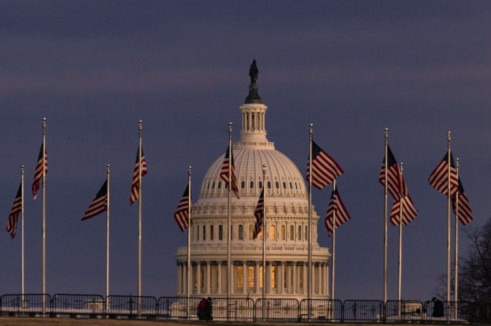 The U.S. Capitol building is seen past the Washington Monument as the sun sets in Washington, D.C., Dec. 26, 2020. ( AFP Photo)