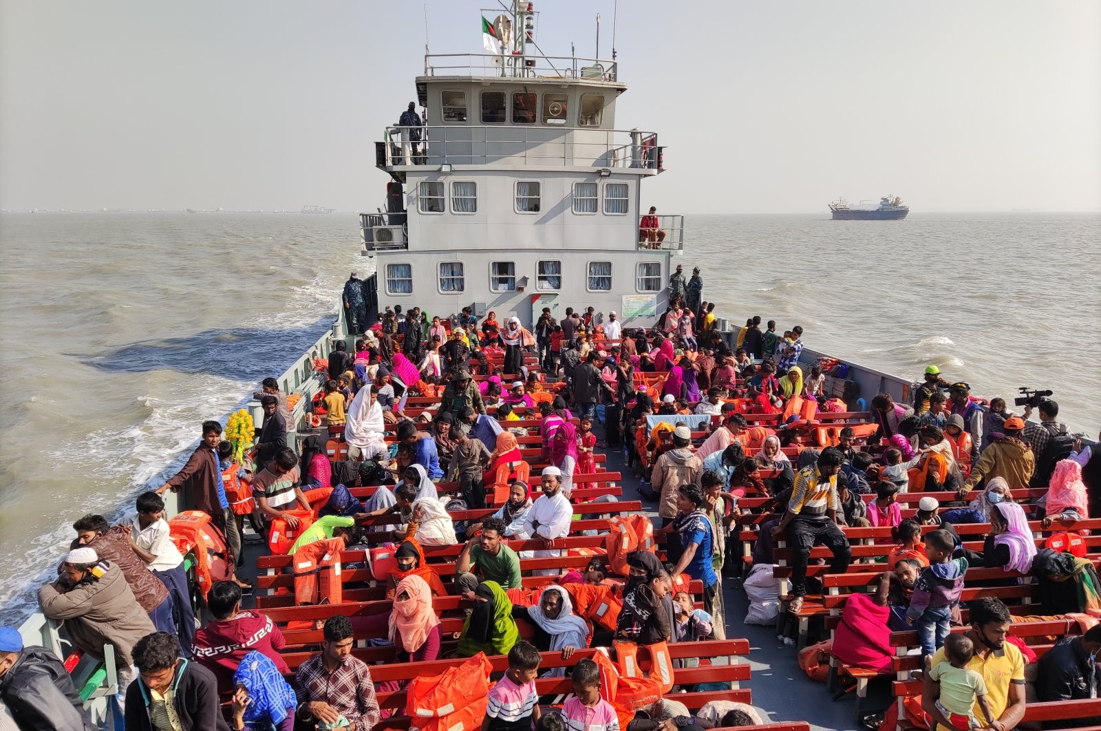 Rohingya refugees travel in a naval ship to be transported to an isolated island in the Bay of Bengal, in Chittagong, Bangladesh, Tuesday, Dec. 29, 2020. (AP Photo)