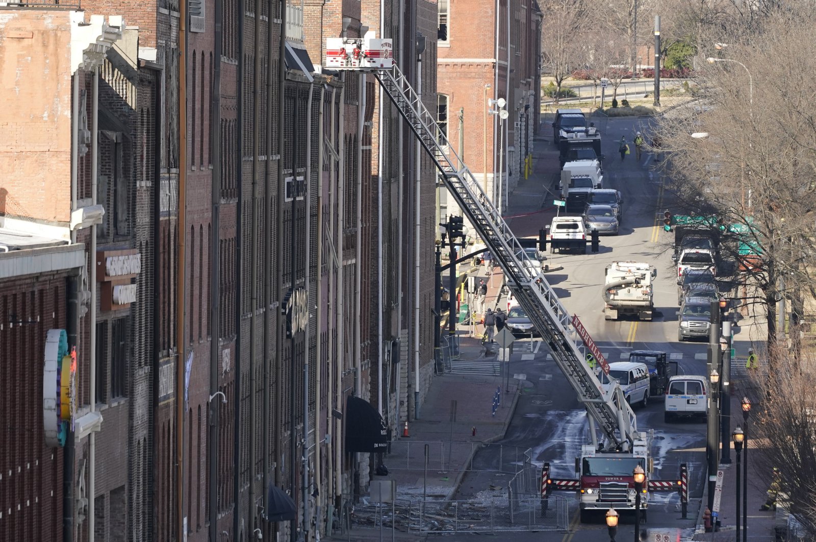 Firefighters ride on an aerial ladder as they inspect buildings damaged in a Christmas Day explosion in Nashville, Tennessee, U.S., Dec. 28, 2020. (AP Photo)