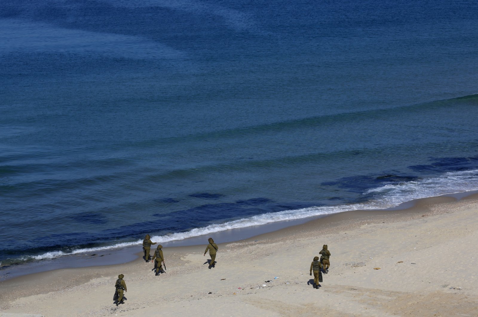 Palestinian militants patrol on the beach of the Mediterranean Sea during a military drill organized by military factions outside Gaza City, Tuesday, Dec. 29, 2020. (AP Photo)