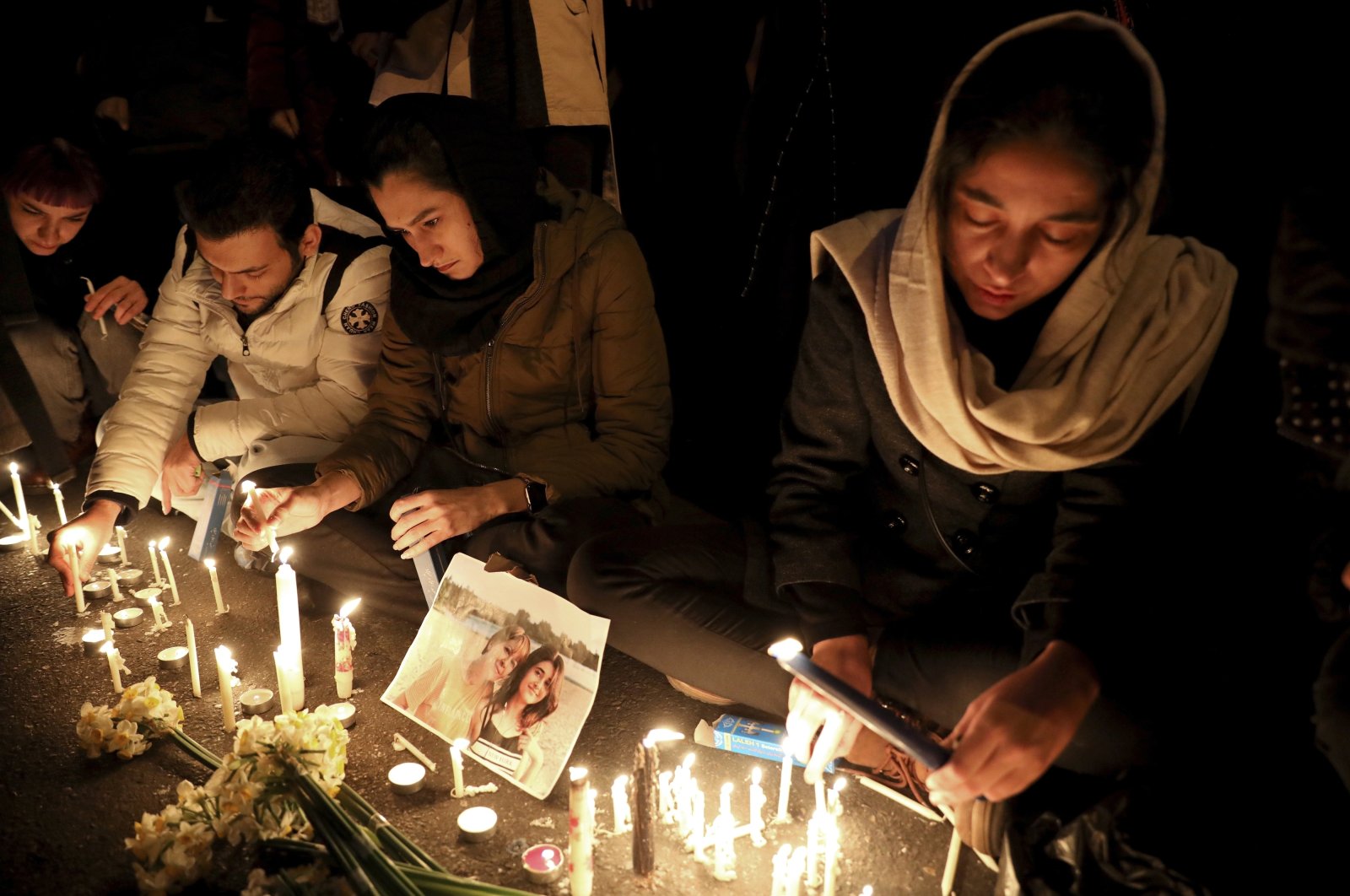 In this Jan. 11, 2020 file photo, people gather for a candlelight vigil to remember the victims of a Ukraine plane crash, at the gate of Amri Kabir University that some of the victims of the crash were former students of, in Tehran, Iran. (AP Photo)