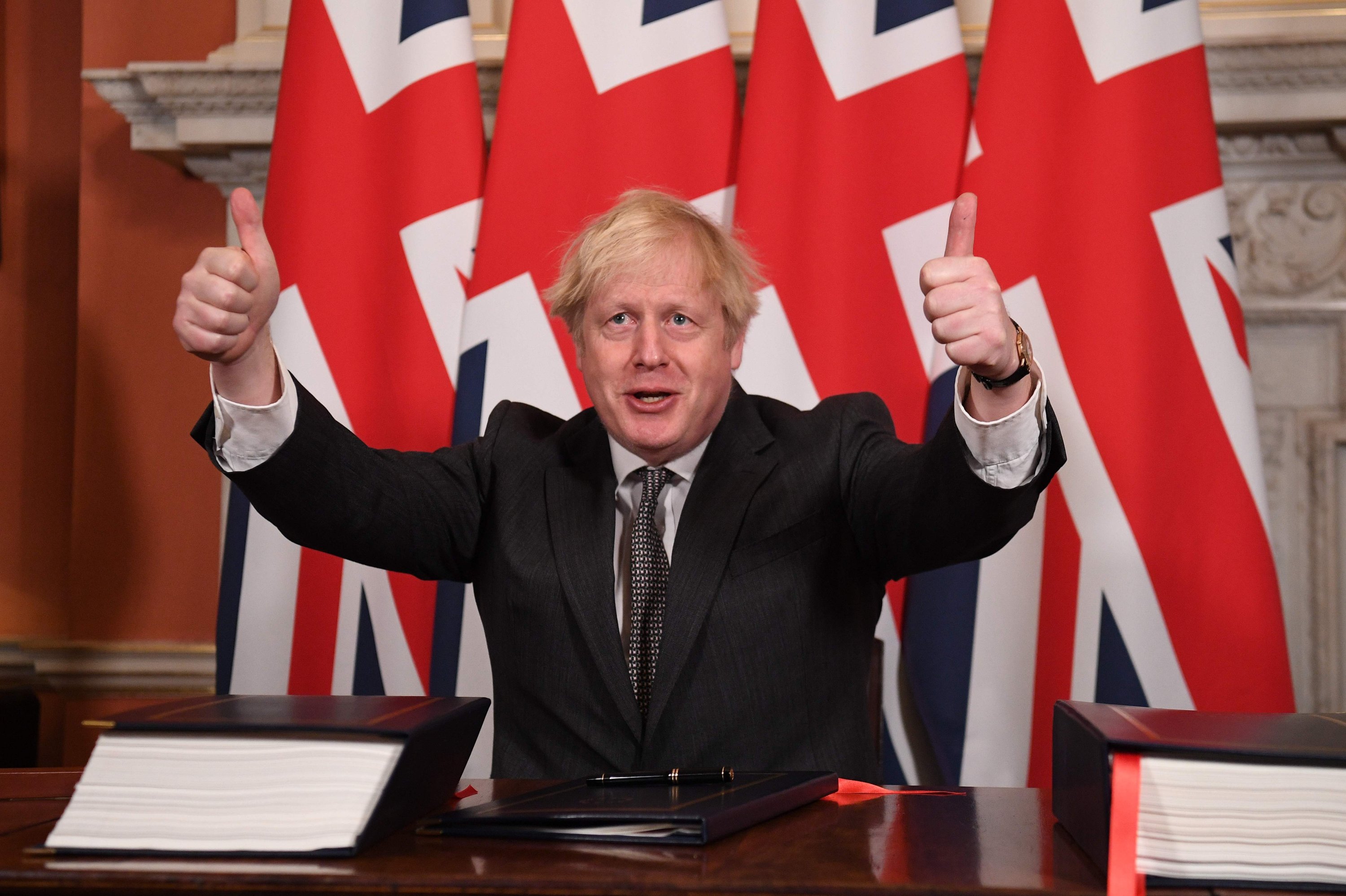 Britain's Prime Minister Boris Johnson gives a double thumbs up after signing the Trade and Cooperation Agreement between the U.K. and the EU, the Brexit trade deal, at 10 Downing Street, central London on Dec. 30, 2020. (AFP Photo)
