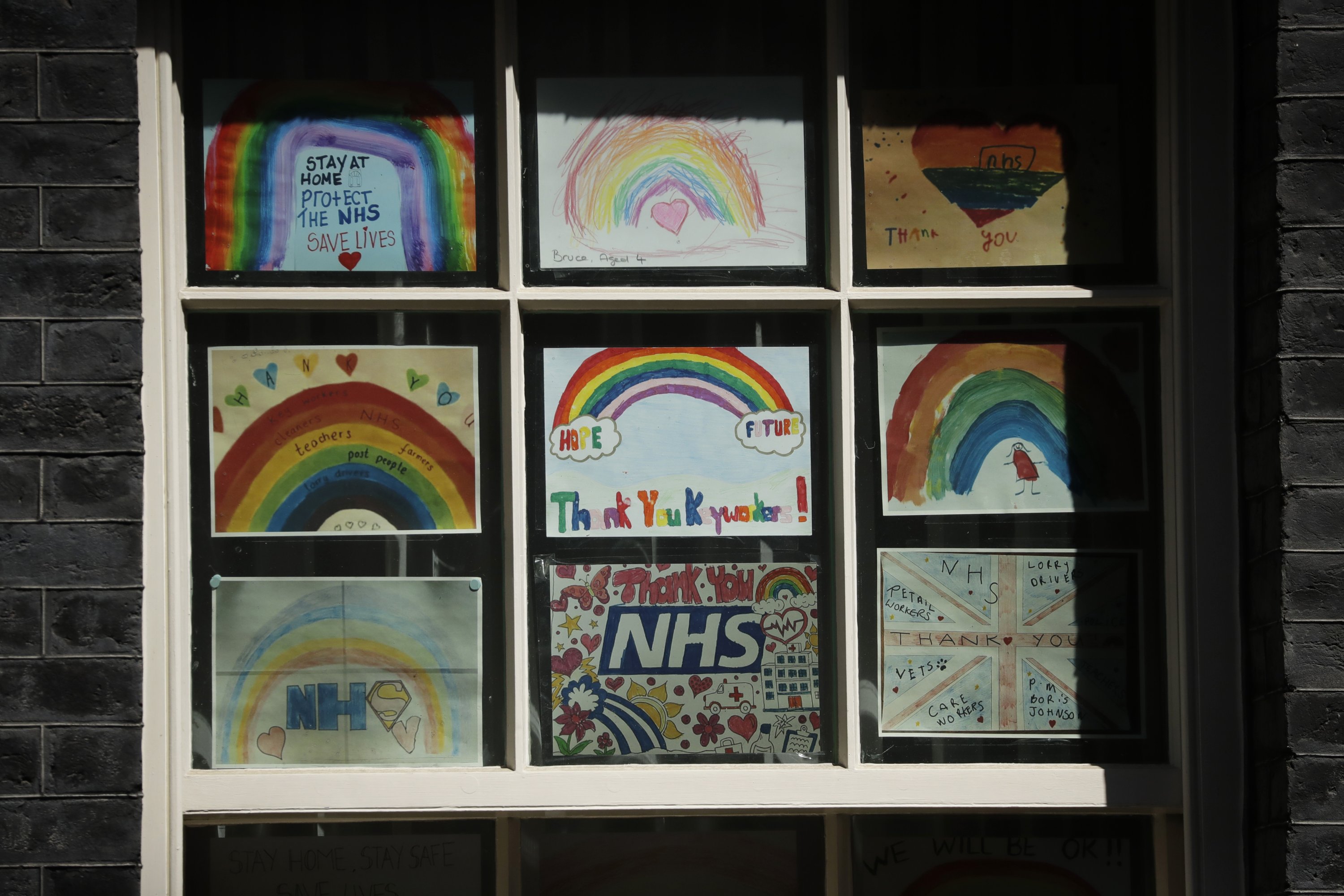 Coronavirus related artworks from children thanking the NHS (National Health Service) are displayed in one of the windows at 10 Downing Street in London, May 6, 2020.  (AP Photo)