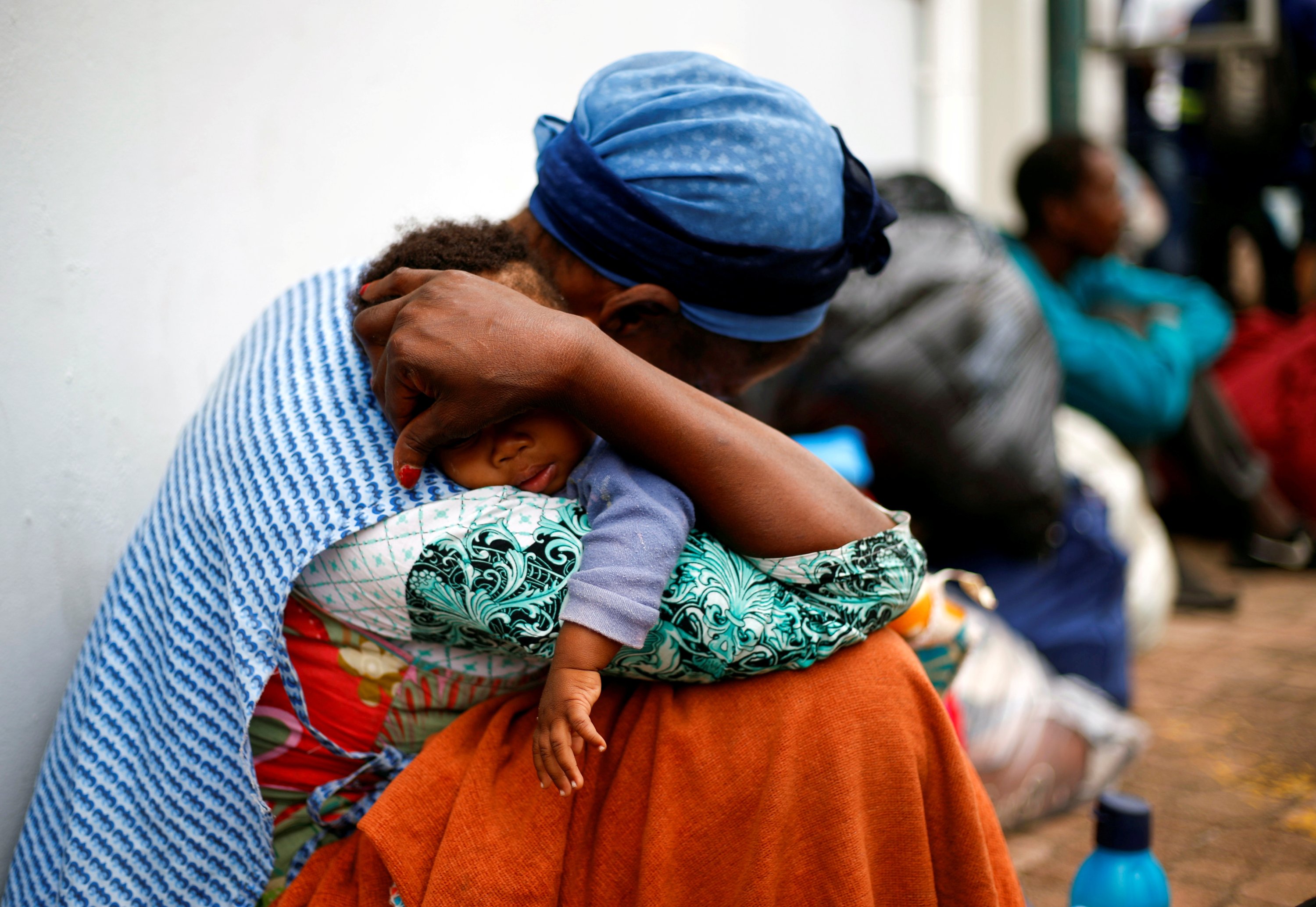 A homeless woman puts her baby to sleep as they queue to be checked by health officials before heading to shelters, during a nationwide 21 day lockdown in Durban, South Africa, March 27, 2020. (REUTERS Photo)