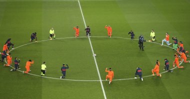 Başakşehir and Paris Saint-Germain players take a knee before the start of a Champions League match at the Parc des Princes stadium, Paris, France, Dec. 9, 2020. (AP Photo)