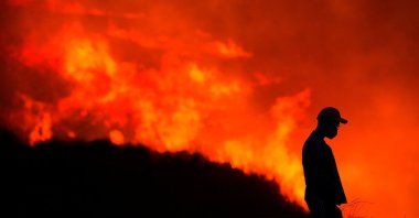 A silhouette of a man is seen as he watches the Blue Ridge Fire burning in Yorba Linda, California, U.S., Oct. 26, 2020. (Reuters Photo)