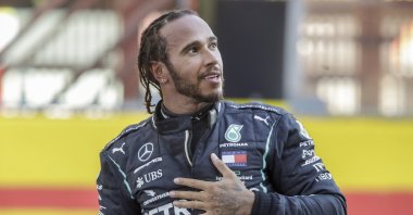 Mercedes driver Lewis Hamilton celebrates after winning the F1 Tuscany Grand Prix, at the Mugello circuit in Scarperia, Italy, Sept. 13, 2020. (AP Photo)