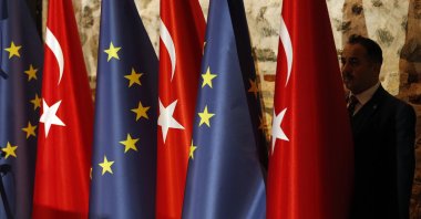 An official adjusts the flags of Turkey and the European Union prior to a bilateral meeting, Istanbul, Turkey, Feb. 28, 2019. (AP Photo)
