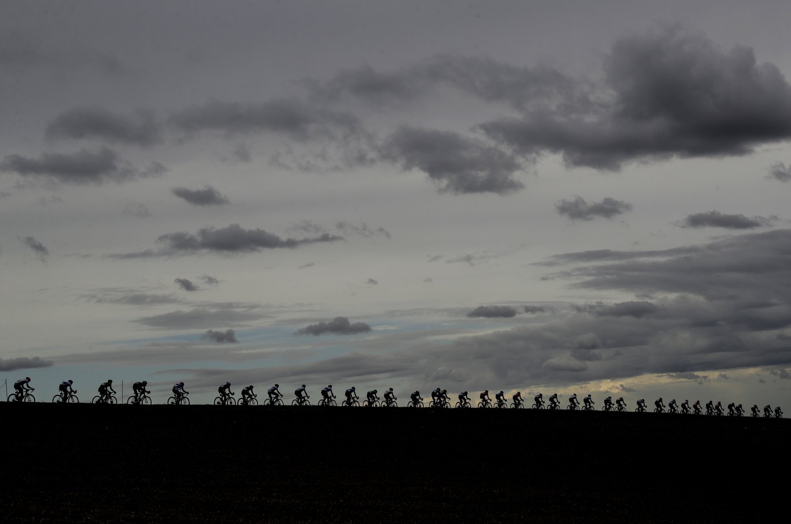 Riders pedal under a cloudy sky during the men's elite event at the road cycling World Championships, in Imola, Italy, Sept. 27, 2020. (AP Photo)