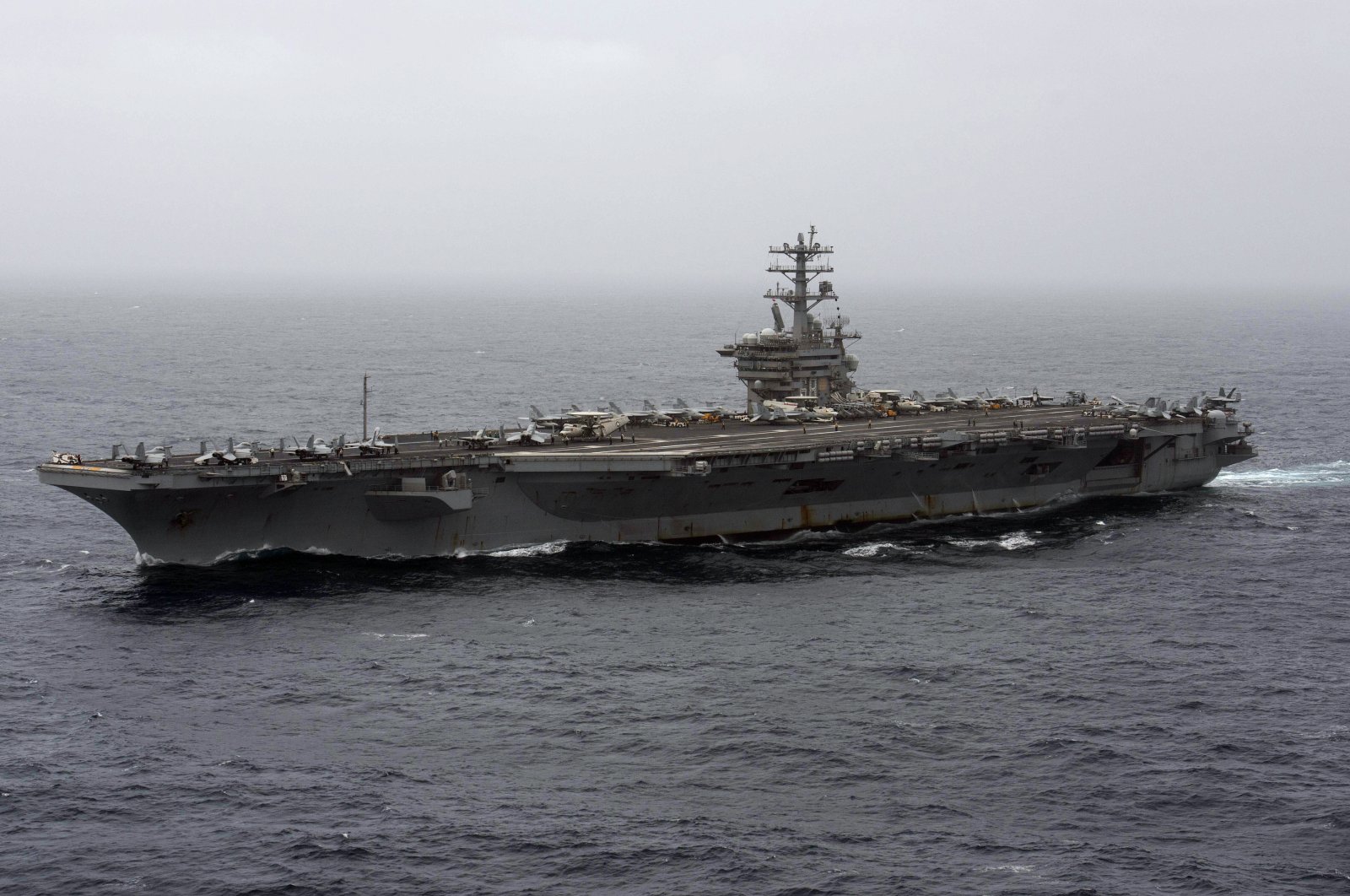 In this Sept. 7, 2020, file photo released by the U.S. Navy, the aircraft carrier USS Nimitz transits the Arabian Sea. The Pentagon announced Thursday, Dec. 31, 2020, that the USS Nimitz, the only Navy aircraft carrier operating in the Middle East, will return home to the U.S. West Coast. (Mass Communication Specialist 3rd Class Elliot Schaudt / U.S. Navy via AP)