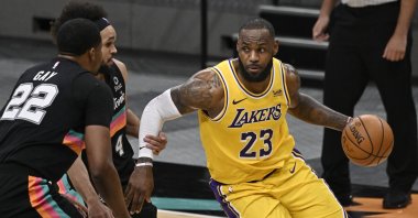 Los Angeles Lakers' LeBron James (23) drives against San Antonio Spurs' Rudy Gay (22) and Derrick White during the second half of an NBA basketball game Friday, Jan. 1, 2021, in San Antonio. (AP Photo)