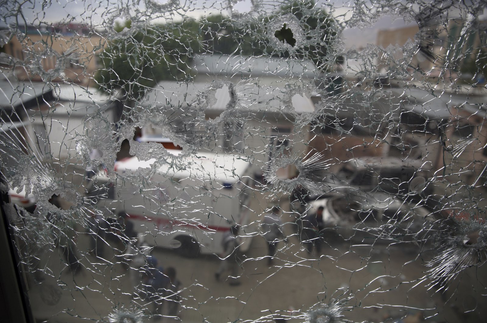 Afghan security officers are seen through the shattered window of a maternity hospital after an attack, in Kabul, Afghanistan, May 12, 2020. (AP Photo)