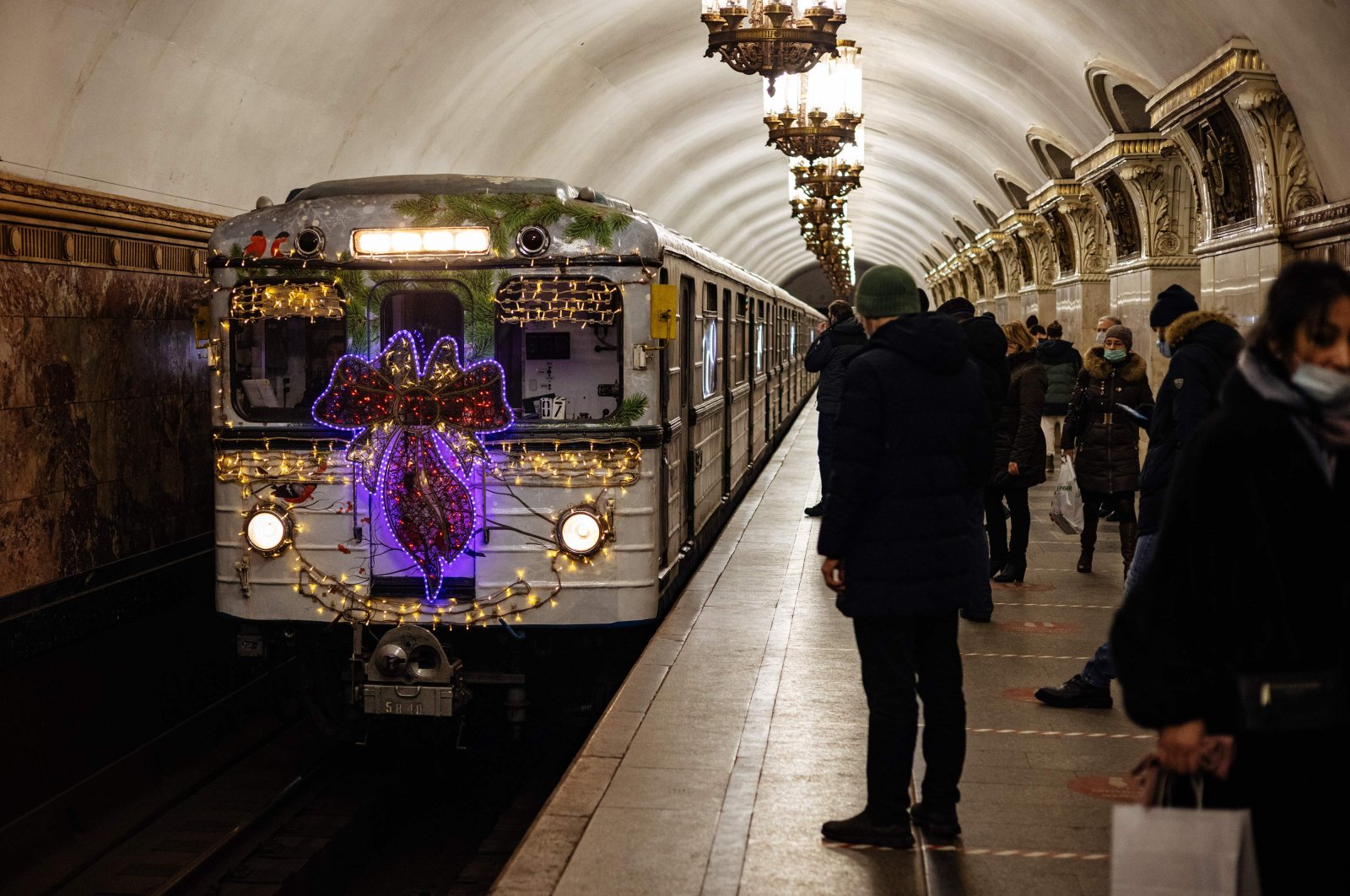 A metro train decorated with Christmas lights arrives at Belorusskaya metro station in Moscow on Dec. 25, 2020. (AFP Photo)