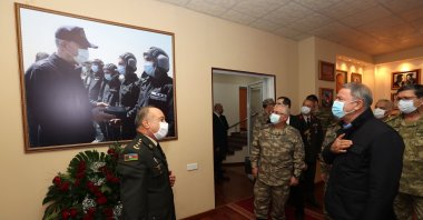 Turkish Defense Minister Hulusi Akar (R) looks at a picture of himself with Lt. Valeh Memiyev, who was killed during the recent Karabakh war, in the capital Baku, Azerbaijan, Jan. 3, 2021. (AA Photo)