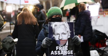 A supporter of WikiLeaks founder Julian Assange holds a placard, at the Old Bailey, the Central Criminal Court, in London, Britain, Jan. 4, 2021. (Reuters Photo)