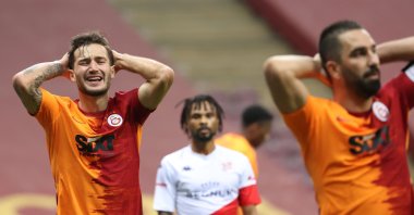 Galatasaray's Oğulcan Çağlayan (L) and Arda Turan (R) react during a Süper Lig match against Antalyaspor at the Türk Telekom Arena, in Istanbul, Turkey, Jan. 2, 2021. (AA Photo)
