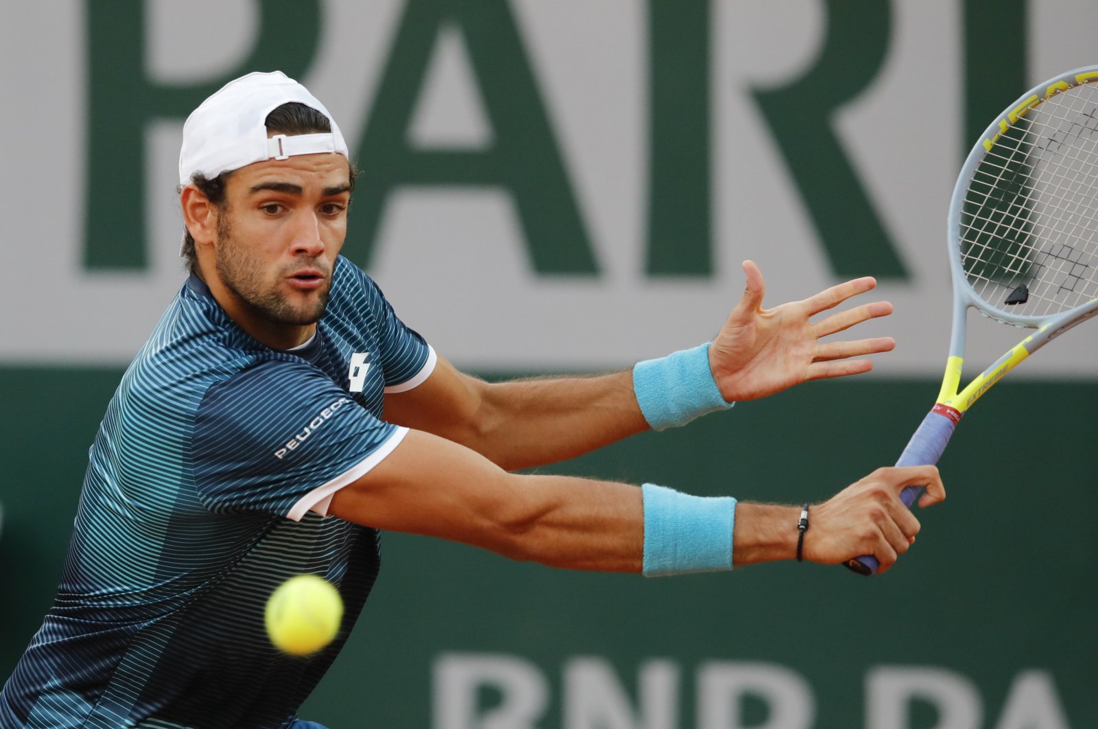 Matteo Berrettini plays a shot against Lloyd Harris during a French Open match at the Roland Garros stadium in Paris, France, Oct. 1, 2020. (AP Photo)