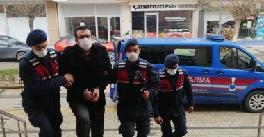 Gendarmerie officers escort a FETÖ suspect captured in the Çan district, in Çanakkale, western Turkey, Jan. 5, 2021. (AA PHOTO) 