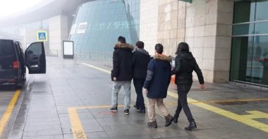 The two suspects escorted out of the airport in the capital Ankara, Turkey, Dec. 6, 2021. (AA Photo)