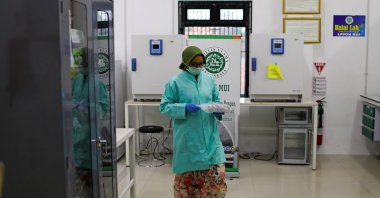 An analyst at the Global Halal Center walks inside a laboratory, where Sinovac's vaccine for the coronavirus disease (COVID-19) was analyzed for halal certification, in Bogor, Indonesia, Jan. 6, 2021. (Reuters Photo)