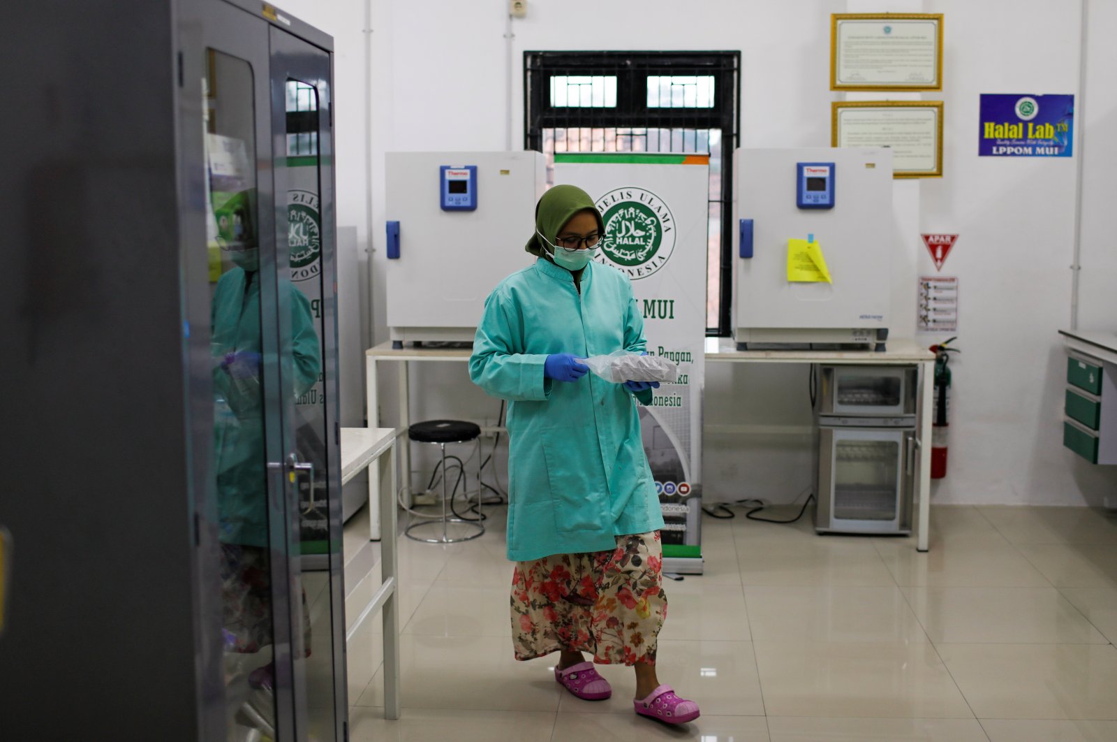 An analyst at the Global Halal Center walks inside a laboratory, where Sinovac's vaccine for the coronavirus disease (COVID-19) was analyzed for halal certification, in Bogor, Indonesia, Jan. 6, 2021. (Reuters Photo)