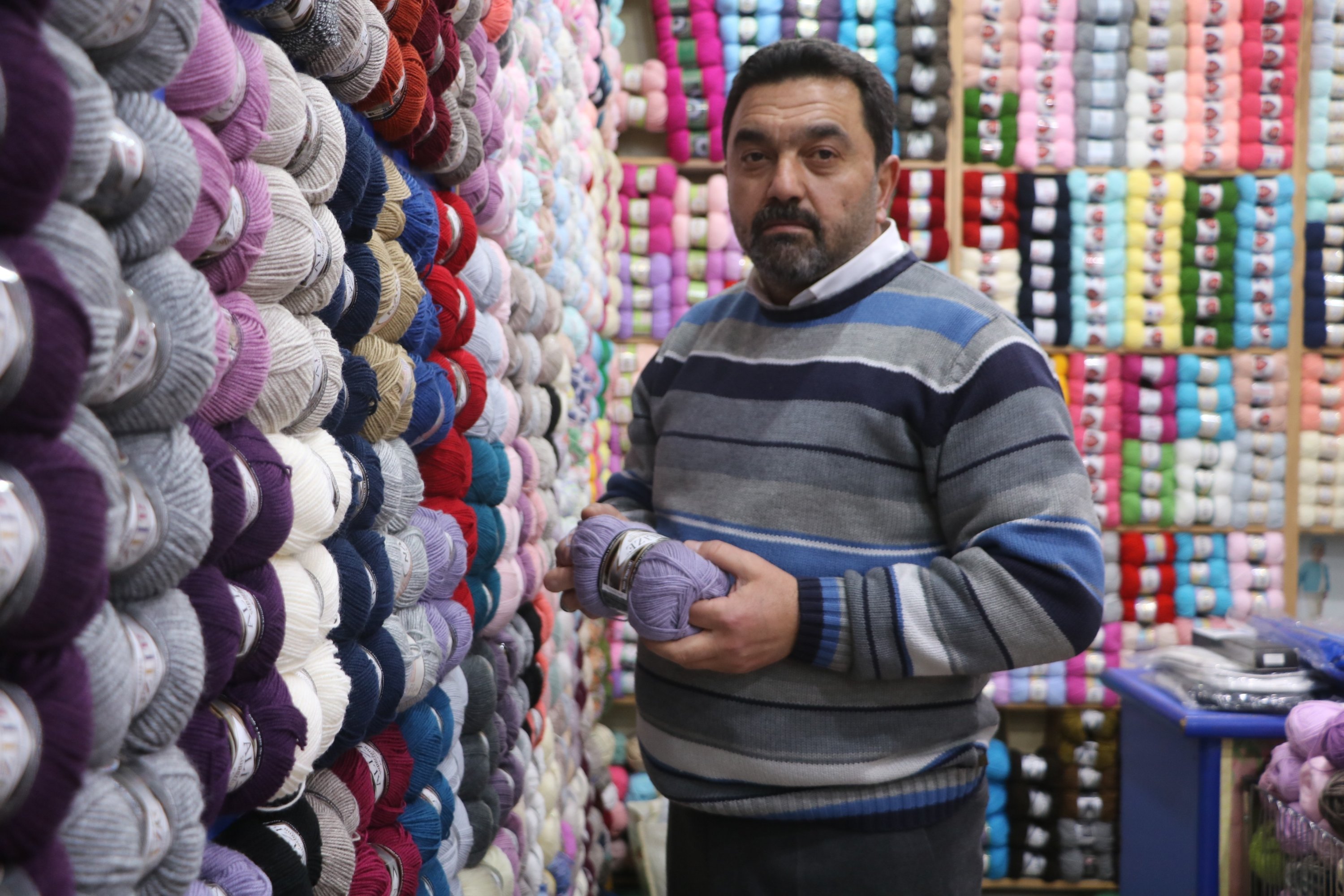 Yıldırım Yalçıner poses in his knitting supplies shop in Sivas, central Turkey, Jan. 7, 2021. (IHA Photo)