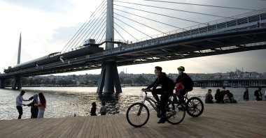 People on bicycles pass the Golden Horn, Istanbul, Turkey, Oct. 10, 2020. (Reuters Photo)