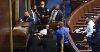 U.S. Capitol Police with guns drawn stand near a barricaded door as protesters try to break into the House Chamber at the U.S. Capitol on Wednesday, Jan. 6, 2021, in Washington. (AP Photo)