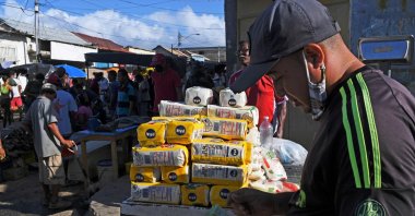 A Venezuelan merchant waits for customers as he sells corn flour at the street market in Guiria, Venezuela, Dec. 19, 2020. (AFP Photo)