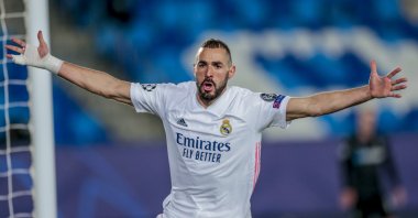 Real Madrid's Karim Benzema celebrates after scoring the opening goal during the Champions League group B football match between Real Madrid and Borussia Monchengladbach at the Alfredo Di Stefano stadium in Madrid, Spain, Dec. 9, 2020. (AP Photo)
