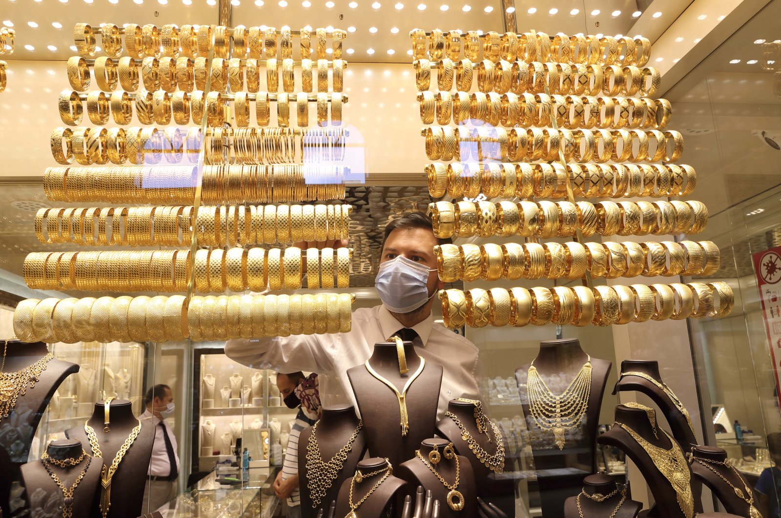 A goldsmith wearing a protective mask arranges golden bangles at a jewelry shop at the Grand Bazaar in Istanbul, Turkey, Aug. 6, 2020. (Reuters Photo)