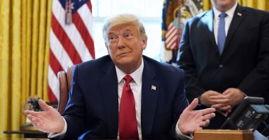 President Donald Trump listens while on a phone call with the leaders of Sudan and Israel, in the Oval Office of the White House, Washington, D.C., Oct. 23, 2020. (AP Photo)