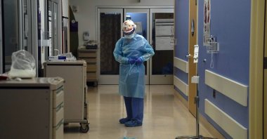 A nurse puts on protective gear in a COVID-19 unit in California, Jan. 7, 2021. (AP Photo)