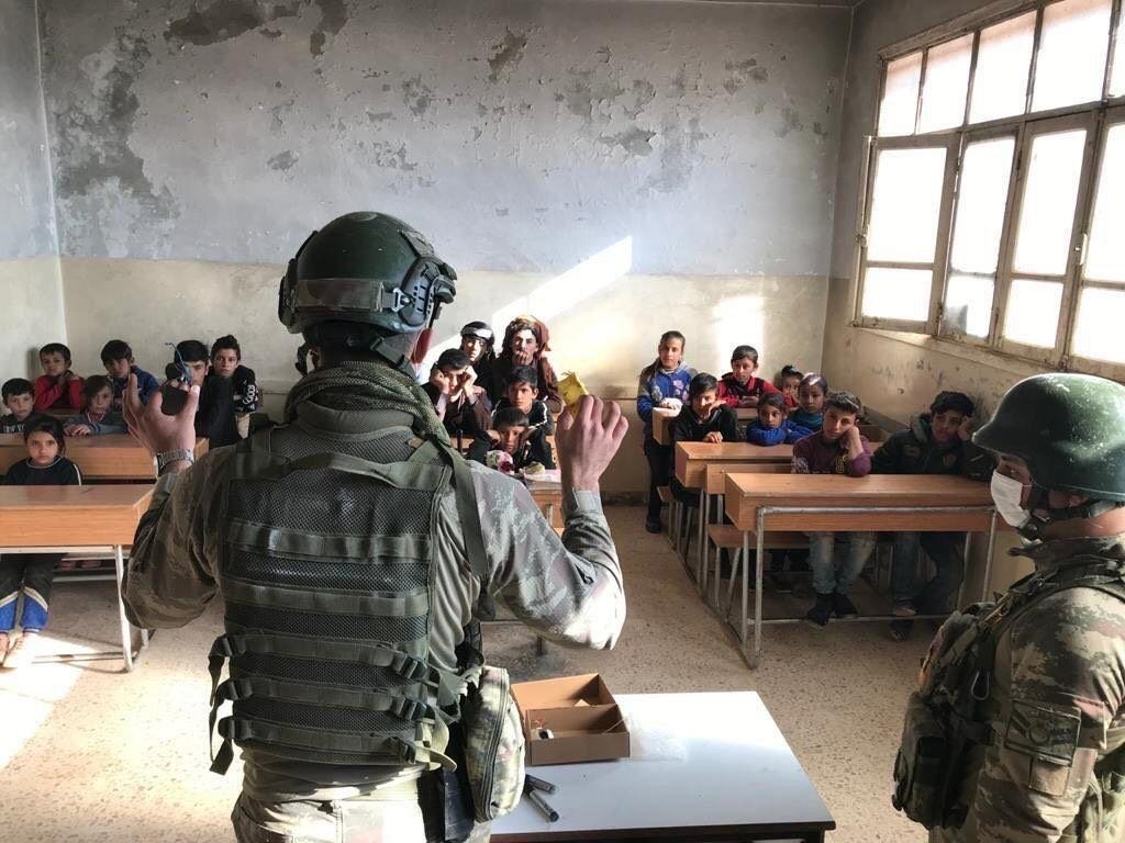 Turkish military personnel teach in an elementary school in northern Syria's Operation Peace Spring area, Jan. 10, 2021. (AA Photo)