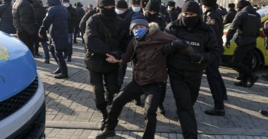 Kazakh police officers detain a protester during an opposition rally in Almaty, Kazakhstan, Sunday, Jan. 10, 2021 (AP Photo)