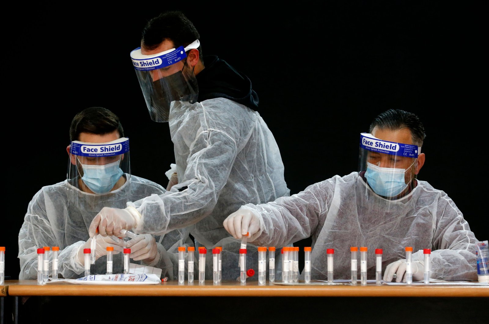 Palestinian health workers register samples for coronavirus testing in the occupied West Bank village of Dura, southwest of Hebron, Jan. 8, 2021. (AFP Photo)