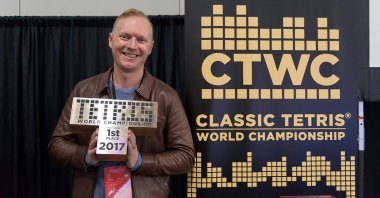 Jonas Neubauer poses with his trophy at the 8th annual Classic Tetris World Championship at the Portland Retro Gaming Expo at the Oregon Convention Center on Oct. 22, 2017. (Image Credit: Classic Tetris World Championship)